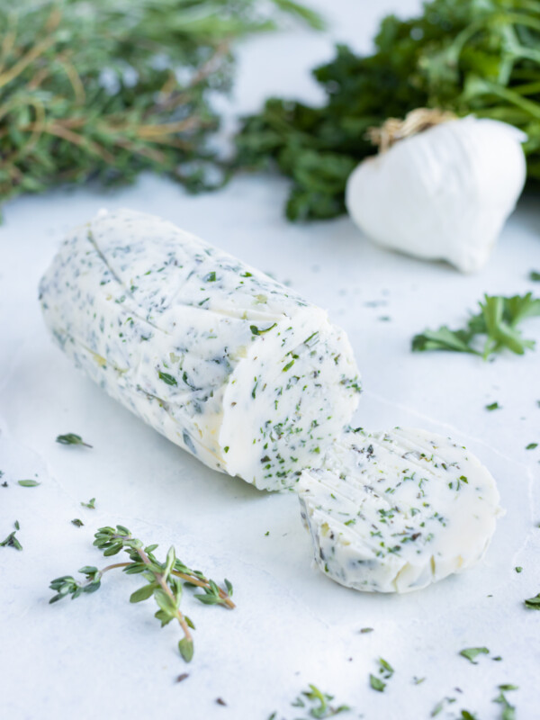 Homemade garlic herb butter is used for vegetables, meats, and breads.