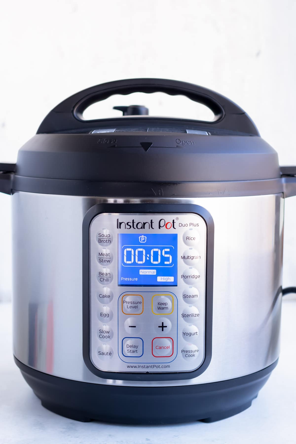 The instant pot timer being set for five minutes.