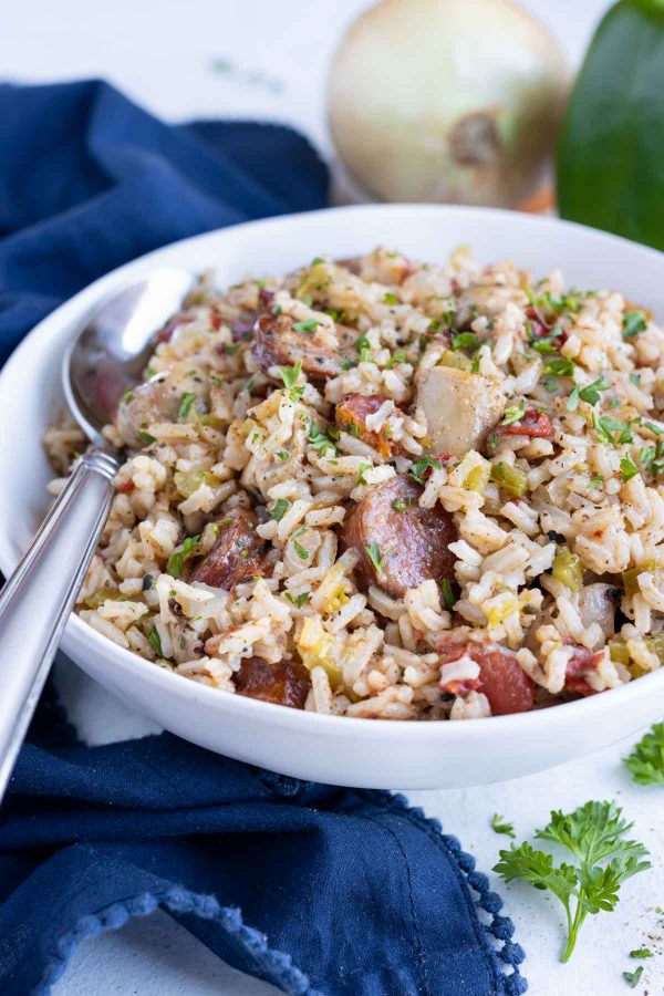 A white bowl is filled with Cajun Jambalaya made in the instant pot.