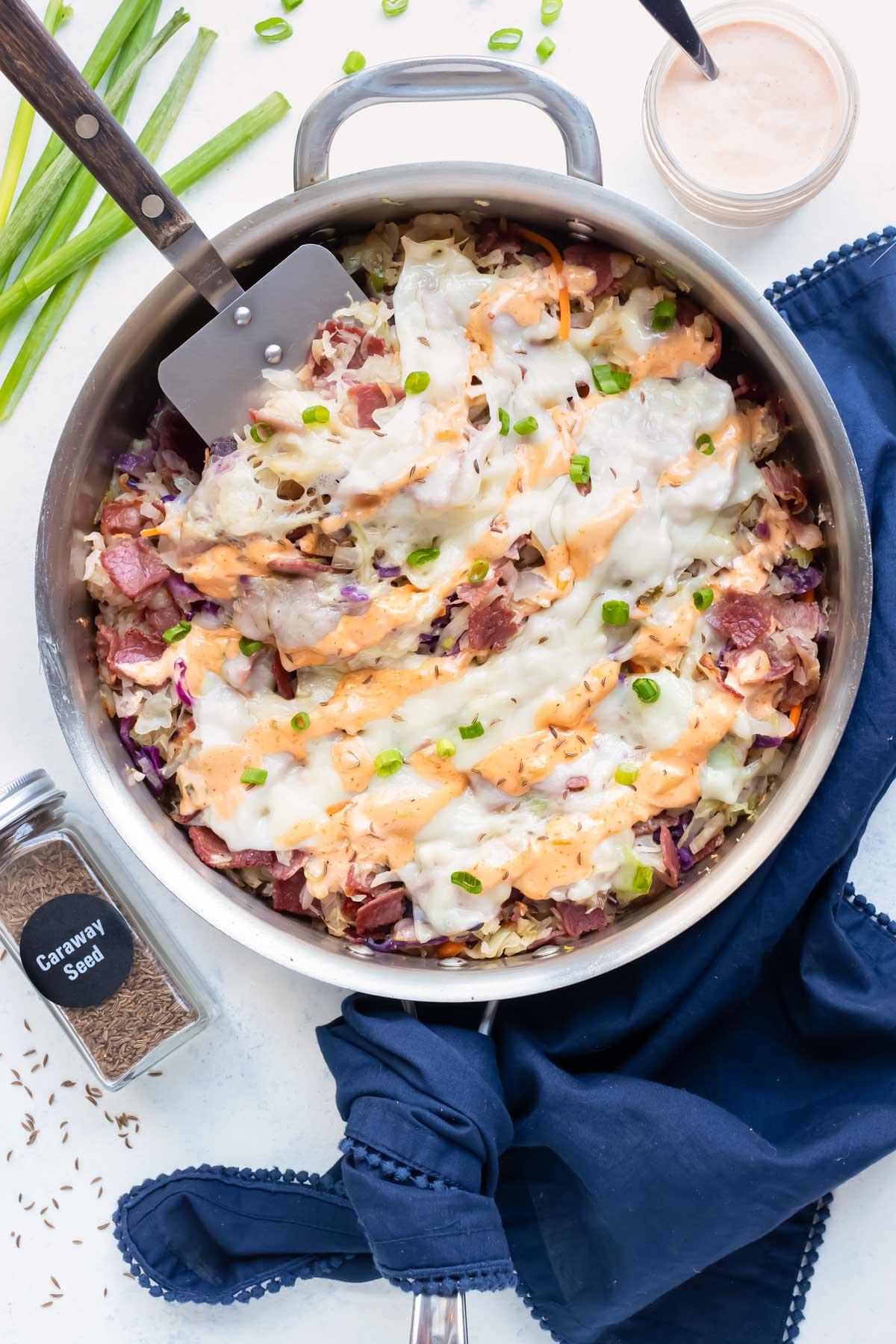 A large skillet of a deconstructed reuben is shown on the counter.