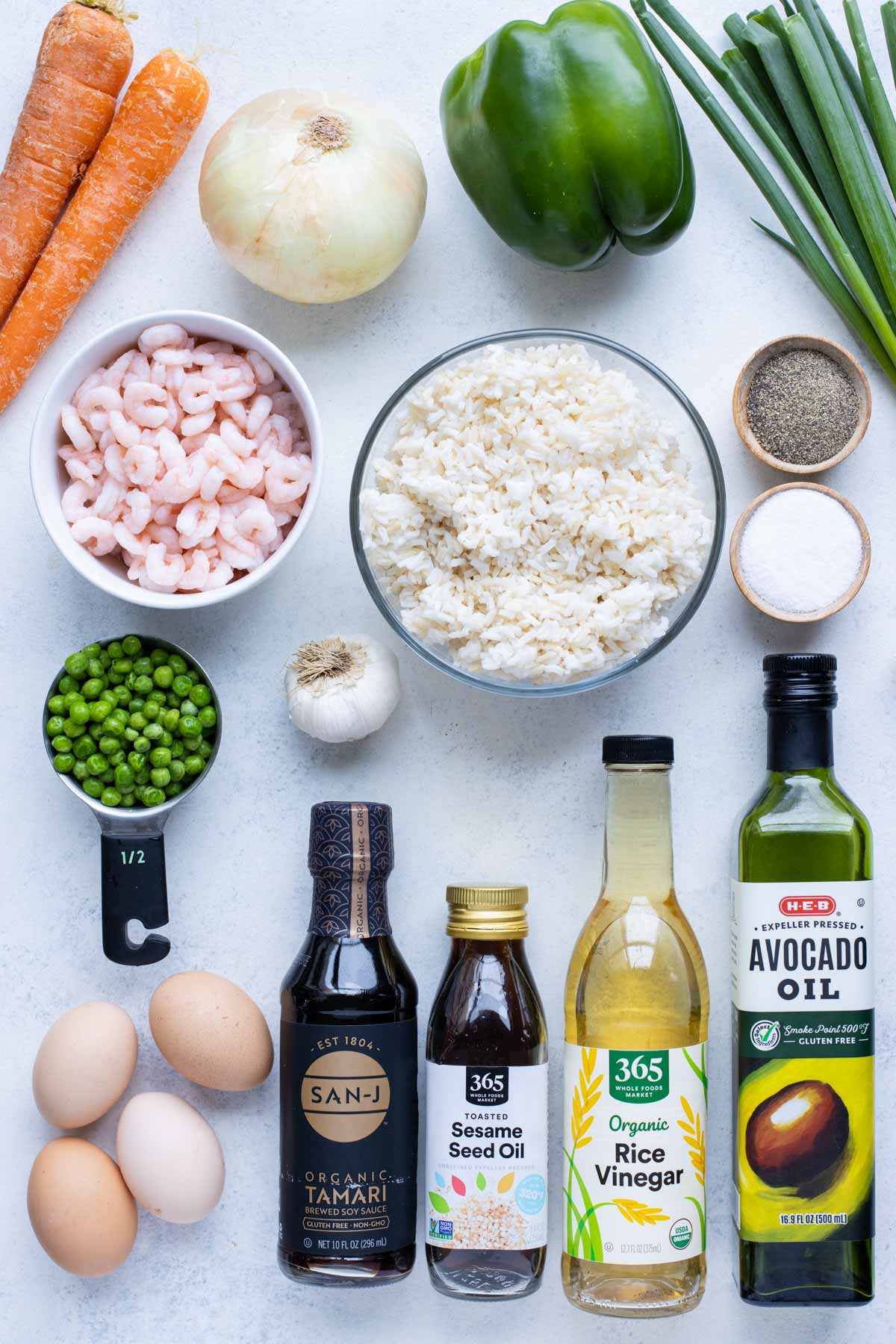 Shrimp, rice, peas, ball peppers, carrots, onion, garlic, egg, seasonings, green onions, oil, rice vinegar, and soy sauce are the ingredients for this recip.