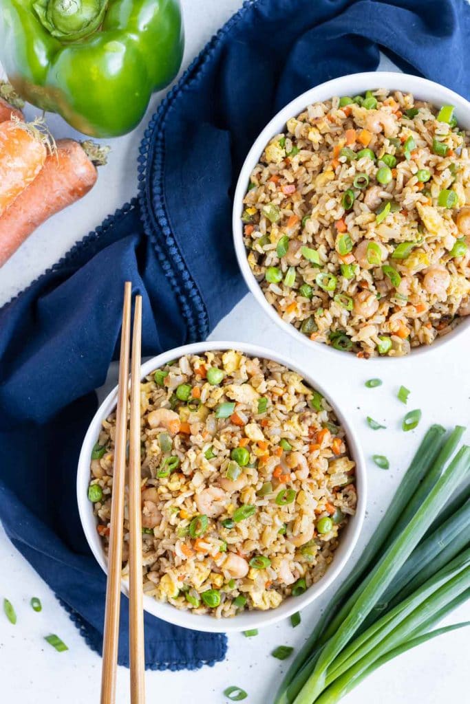 Two bowls are filled with delicious shrimp fried rice.