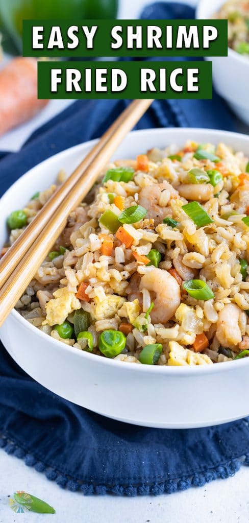 Shrimp fried rice is served in white bowls on the counter.