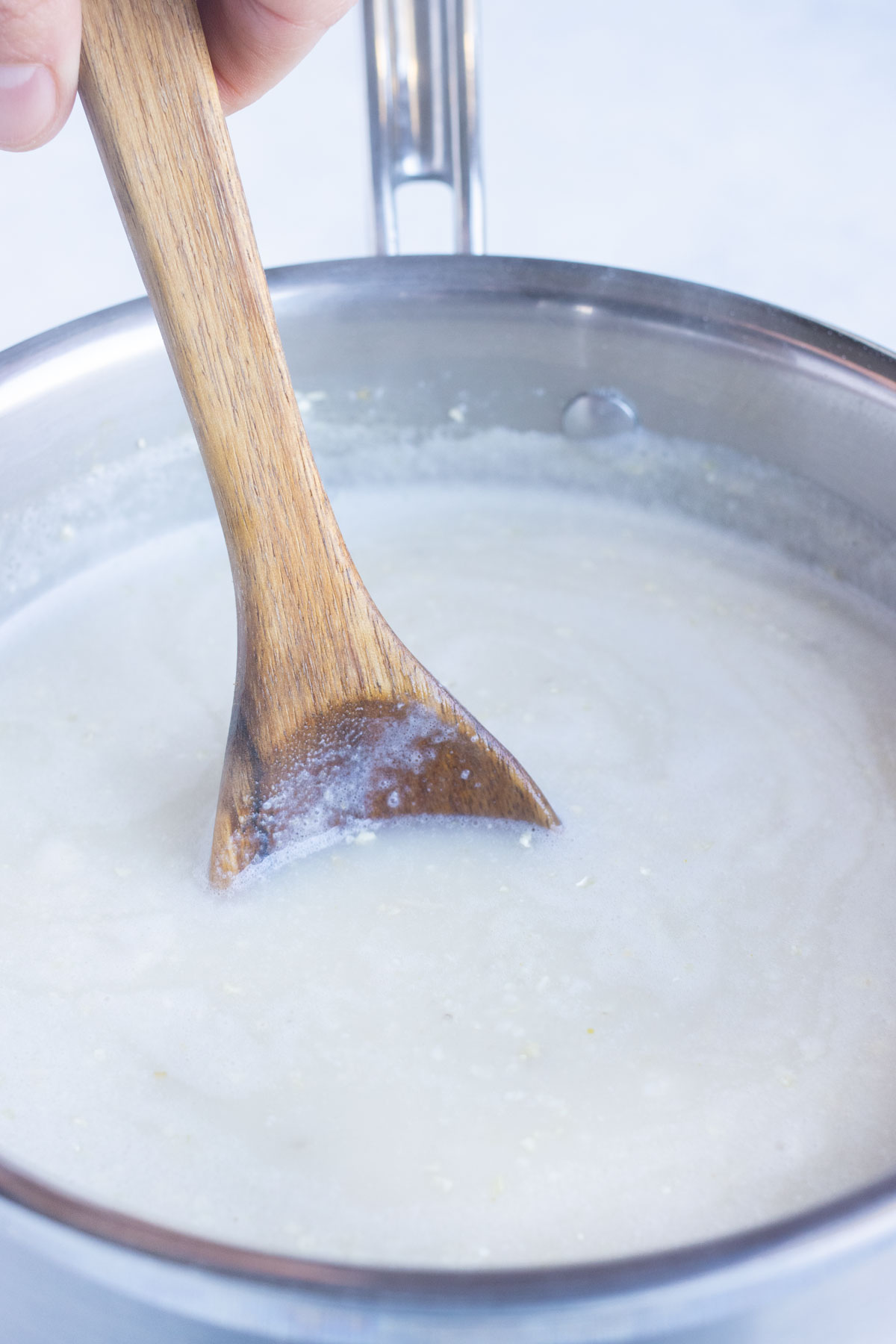 Broth and milk are boiled on the stove.
