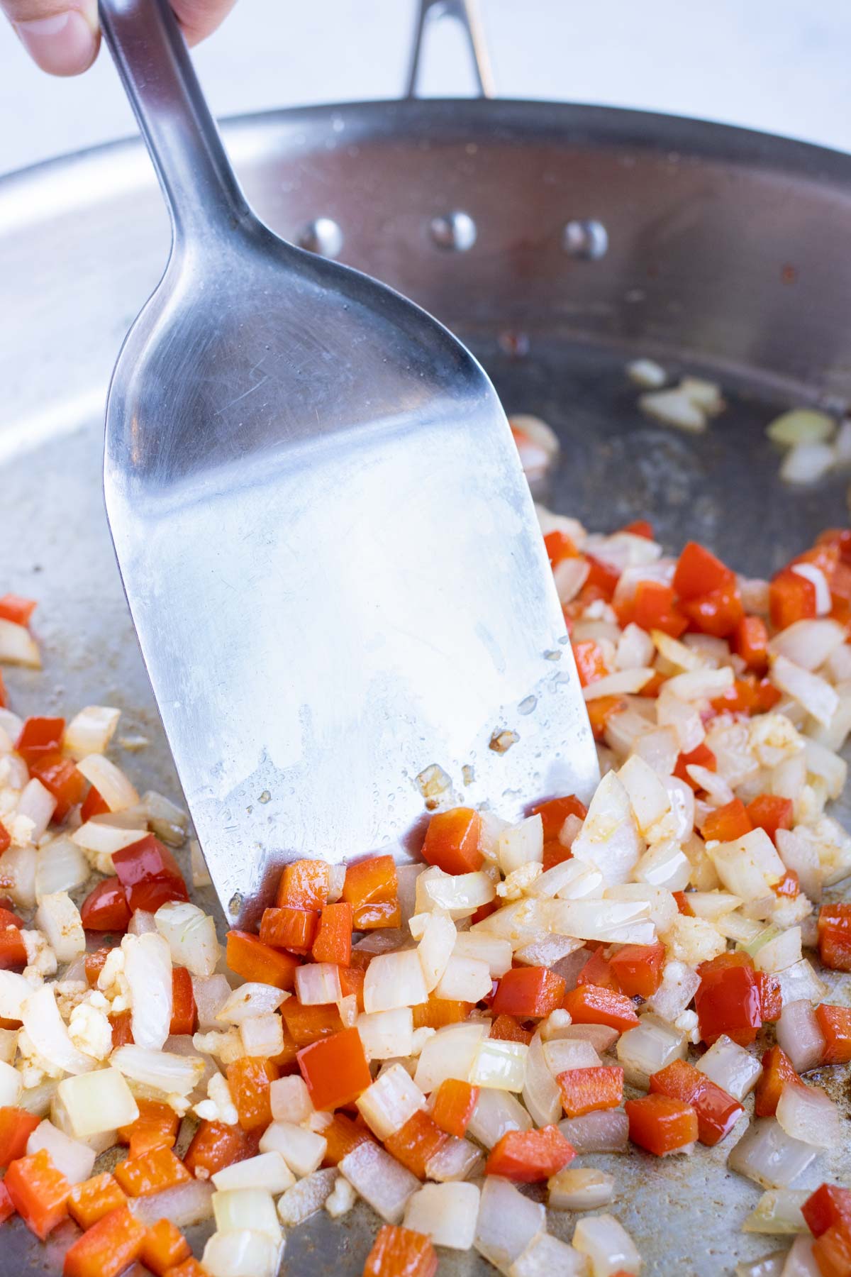 Diced onions and bell peppers are sautèed.