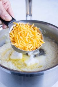 Cheese is added to the grits.