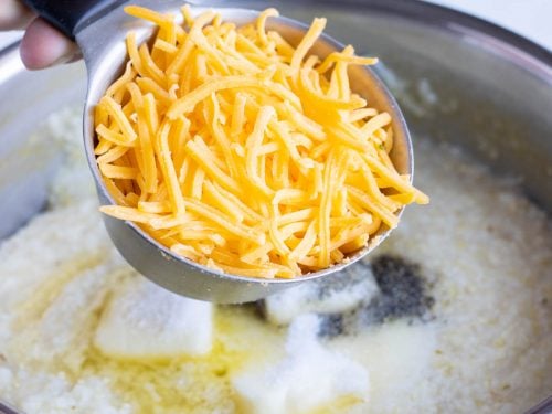 Cheese is added to the grits.