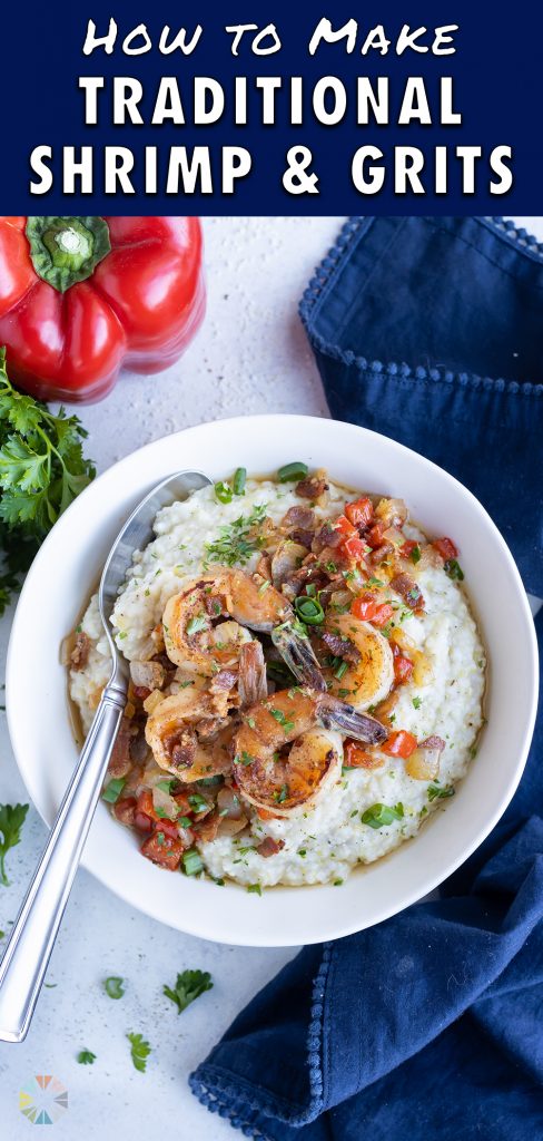 A spoon is shown with a big bowl of shrimp and grits.