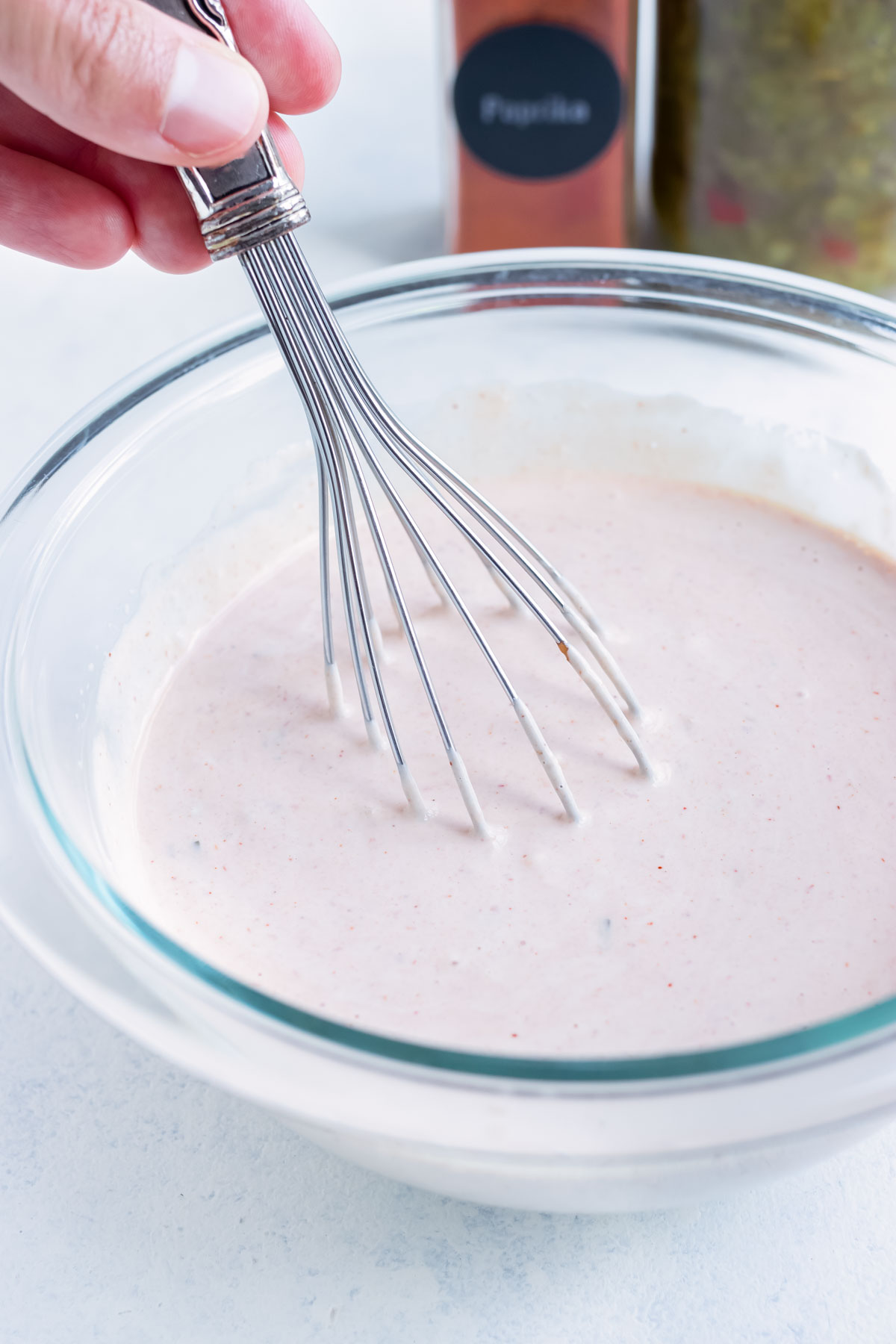 Creamy thousand island dressing is made in a glass bowl.