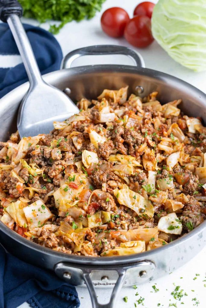 One0pot skillet cabbage recipe is served with a spatula.