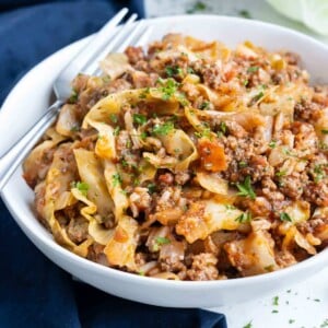 A bowl of unstuffed cabbage rolls is shown on the counter with a fork.