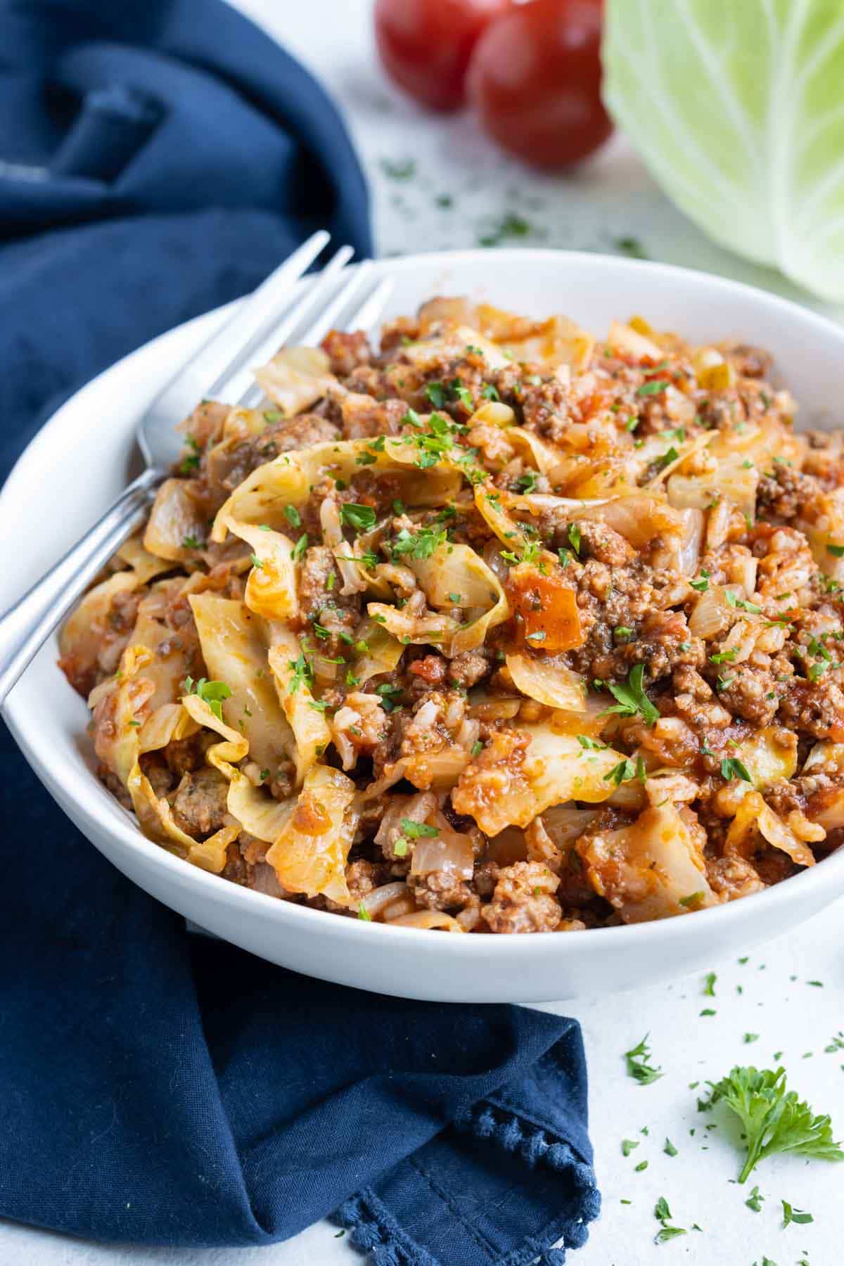 A bowl of unstuffed cabbage rolls is shown on the counter with a fork.