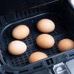 6 eggs are set in the air fryer for hard-boiled eggs.