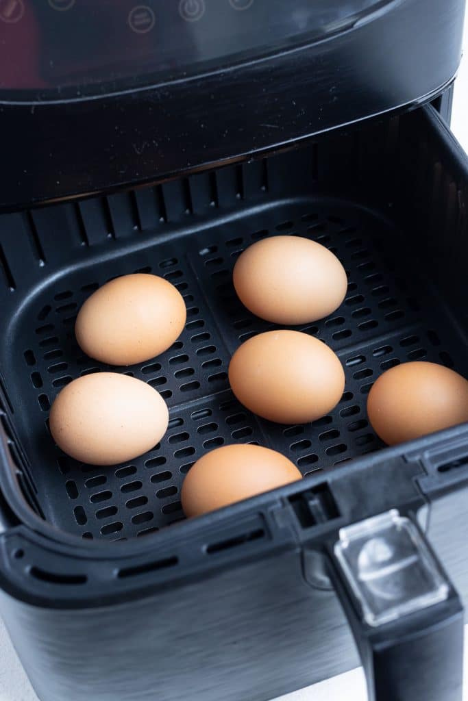6 eggs are set in the air fryer for hard-boiled eggs.