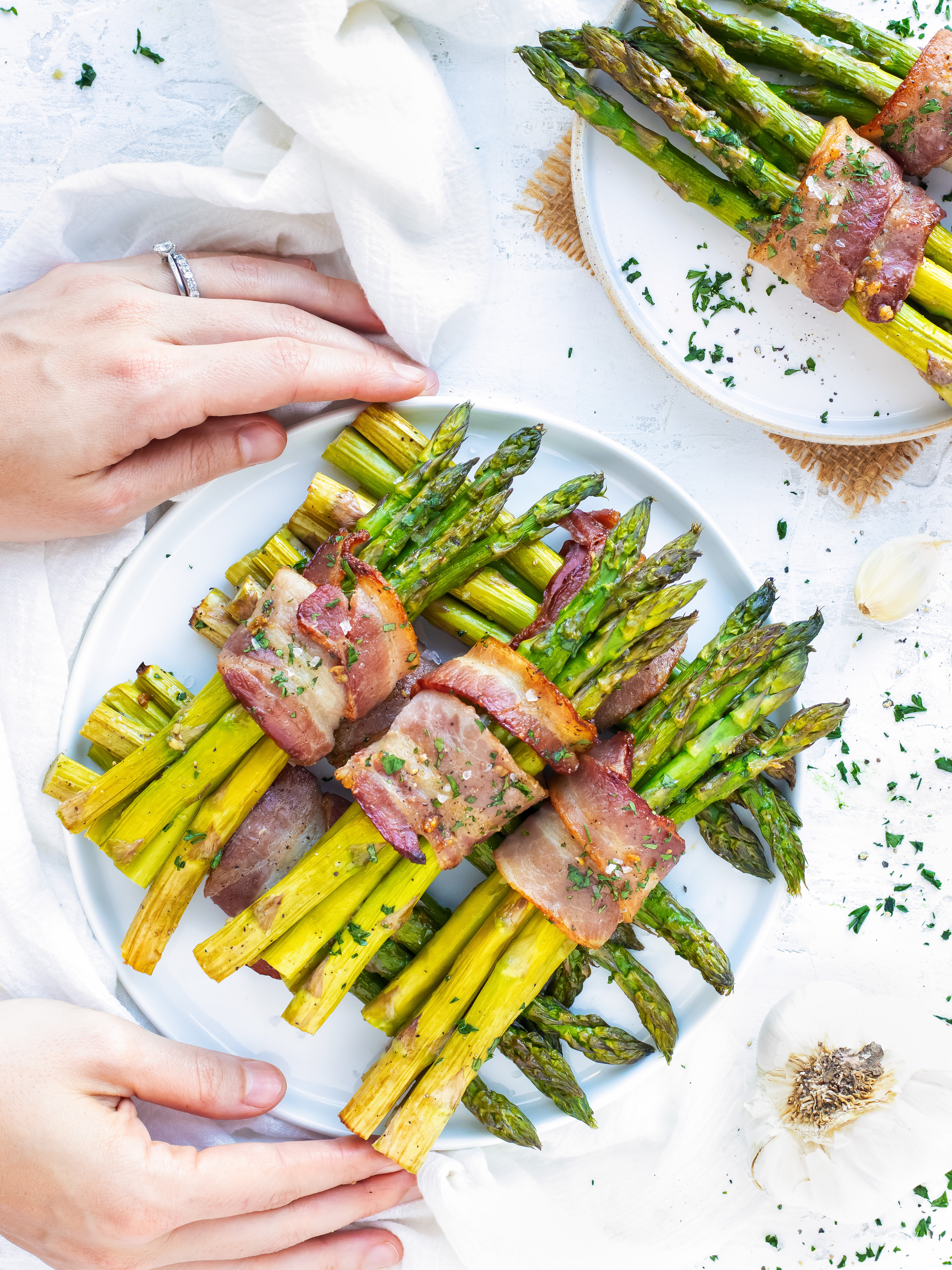 A plate full of bacon wrapped asparagus bundles.