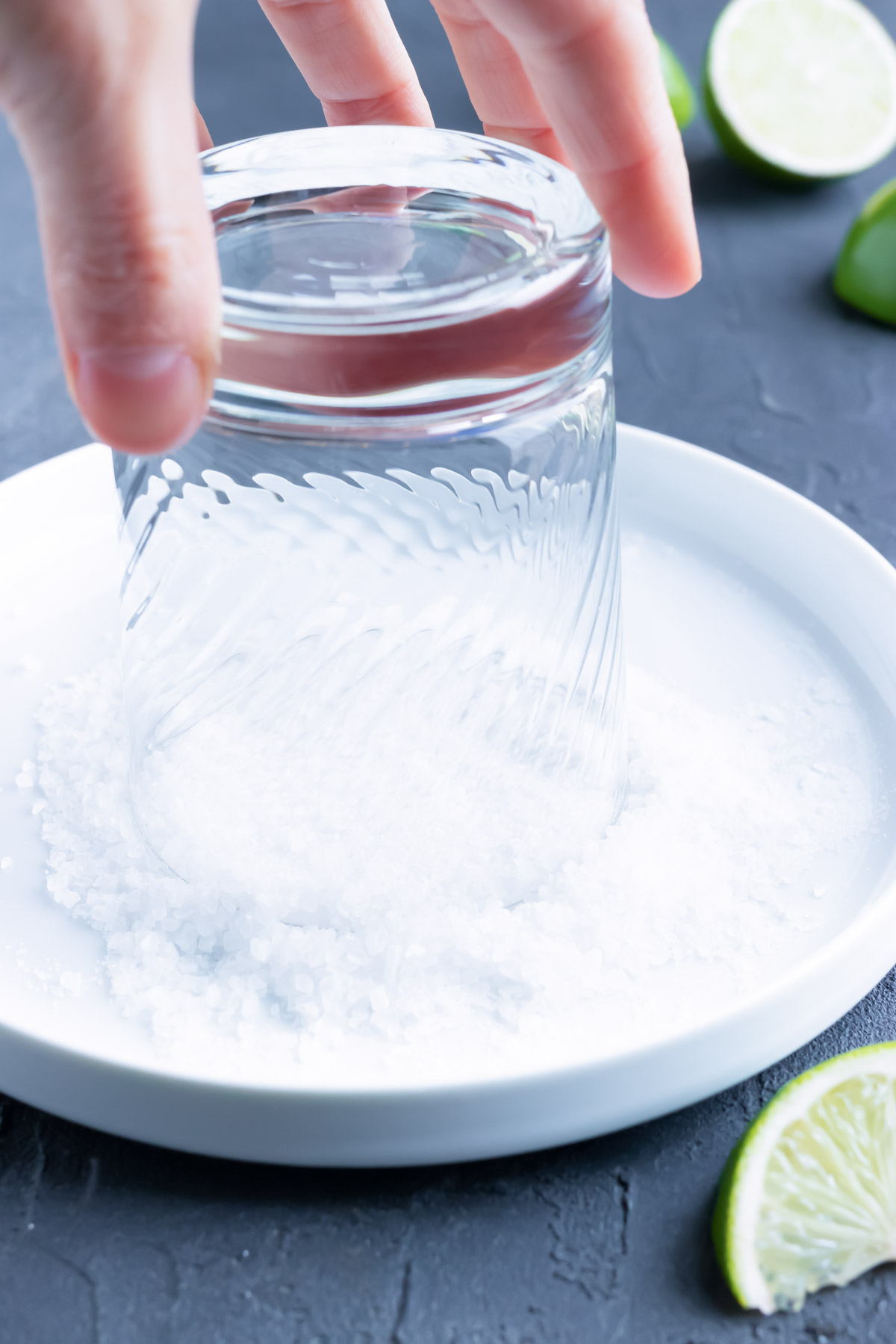 Dip the top of a glass rubbed with lime juice in coarse salt to create a salted rim.