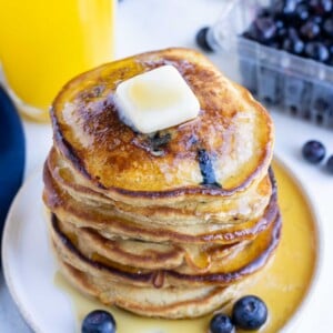 Syrup is served with these fluffy gluten-free blueberry pancakes.