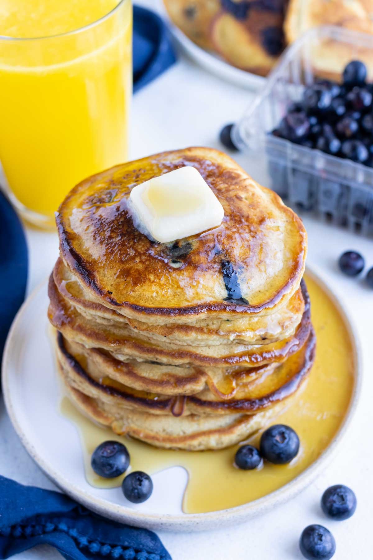 Syrup is served with these fluffy gluten-free blueberry pancakes.