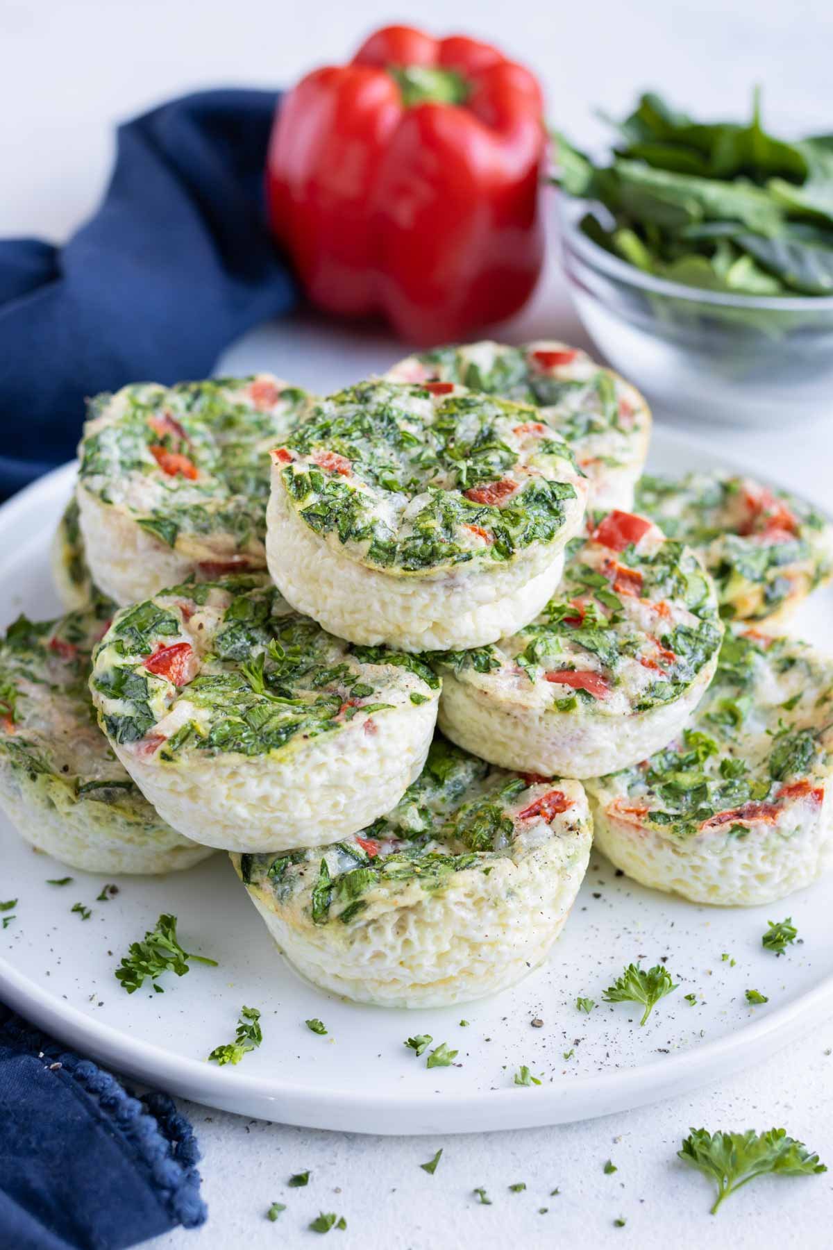 Healthy egg white bites are topped with fresh parsley before eating.
