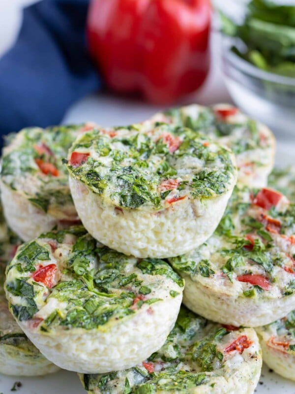 Fluffy egg white bites are shown on a plate near a bell pepper.