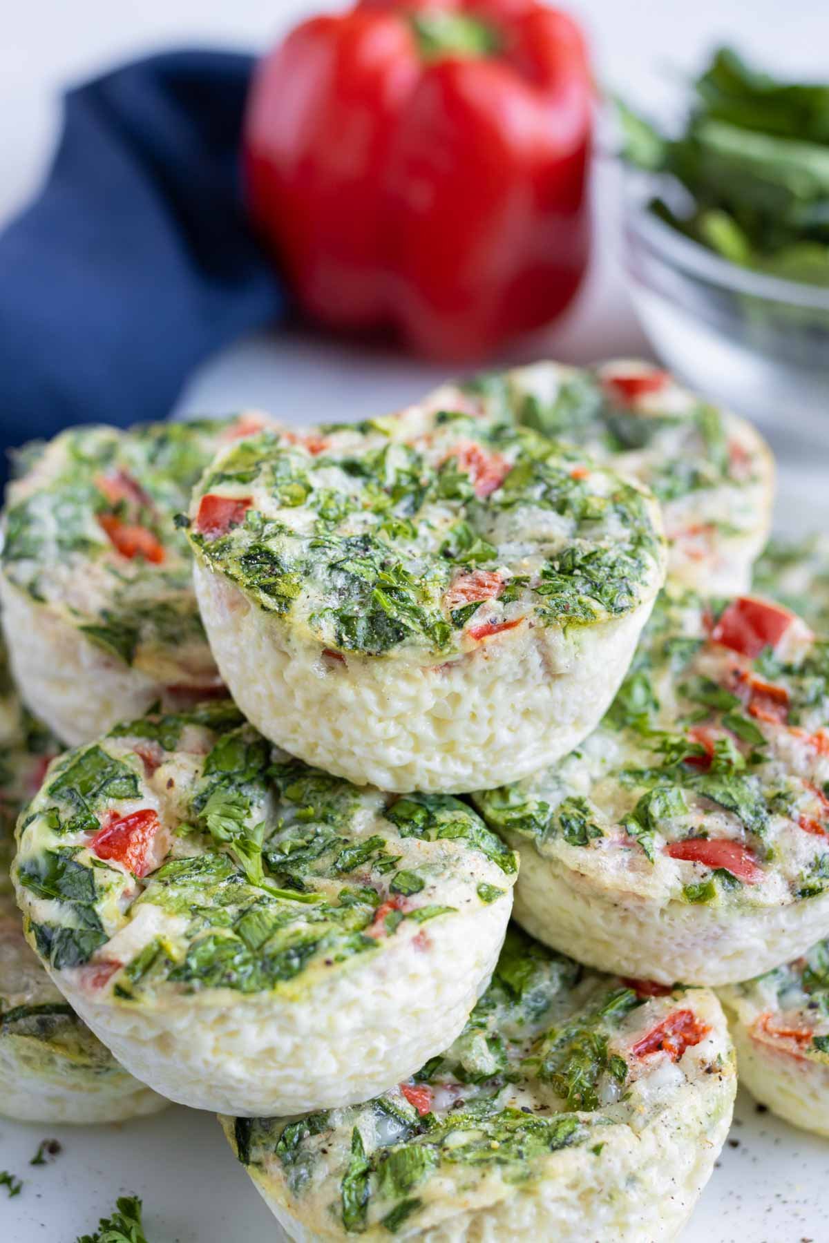 Fluffy egg white bites are shown on a plate near a bell pepper.