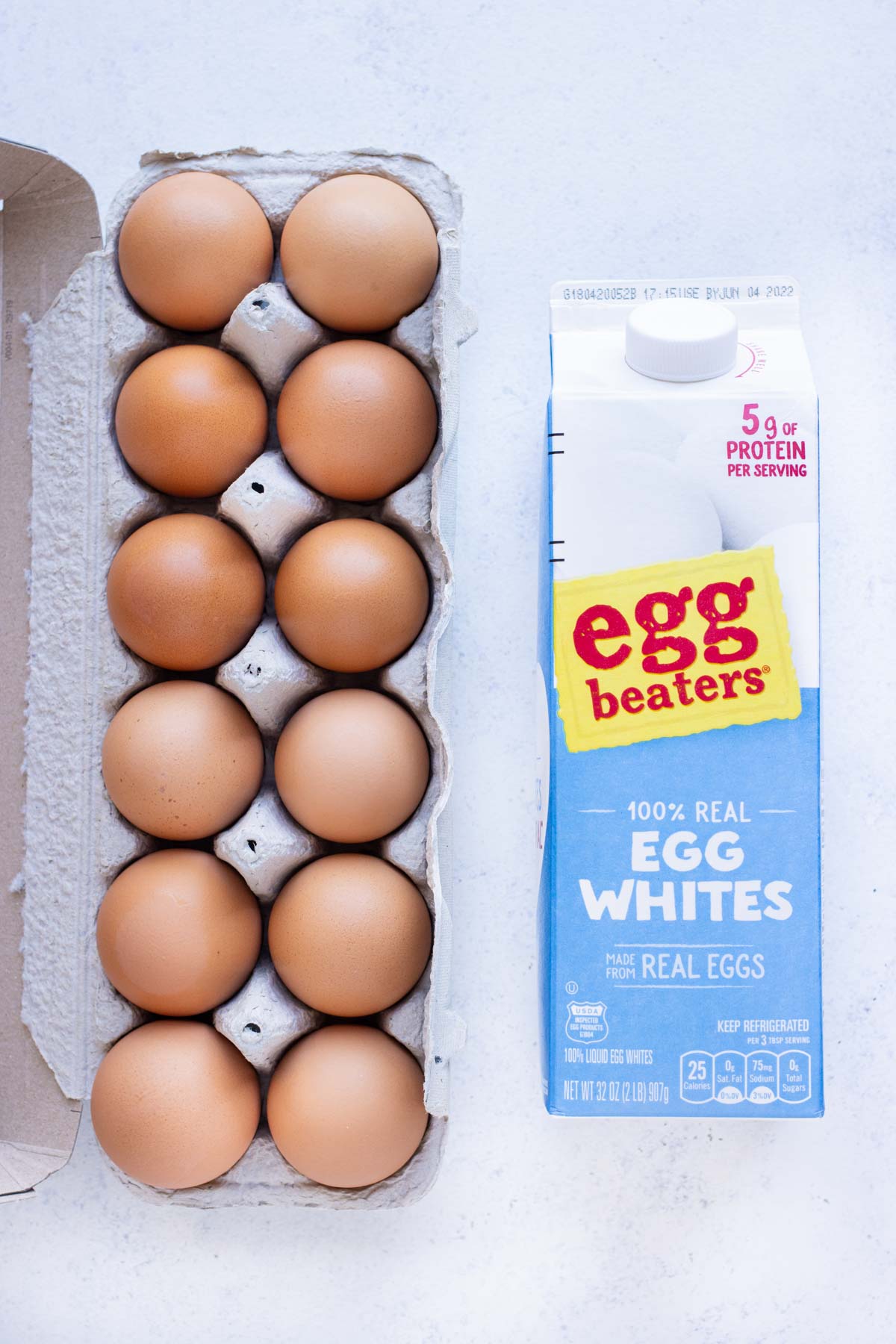 Fresh eggs and a carton of egg whites are shown on the counter.
