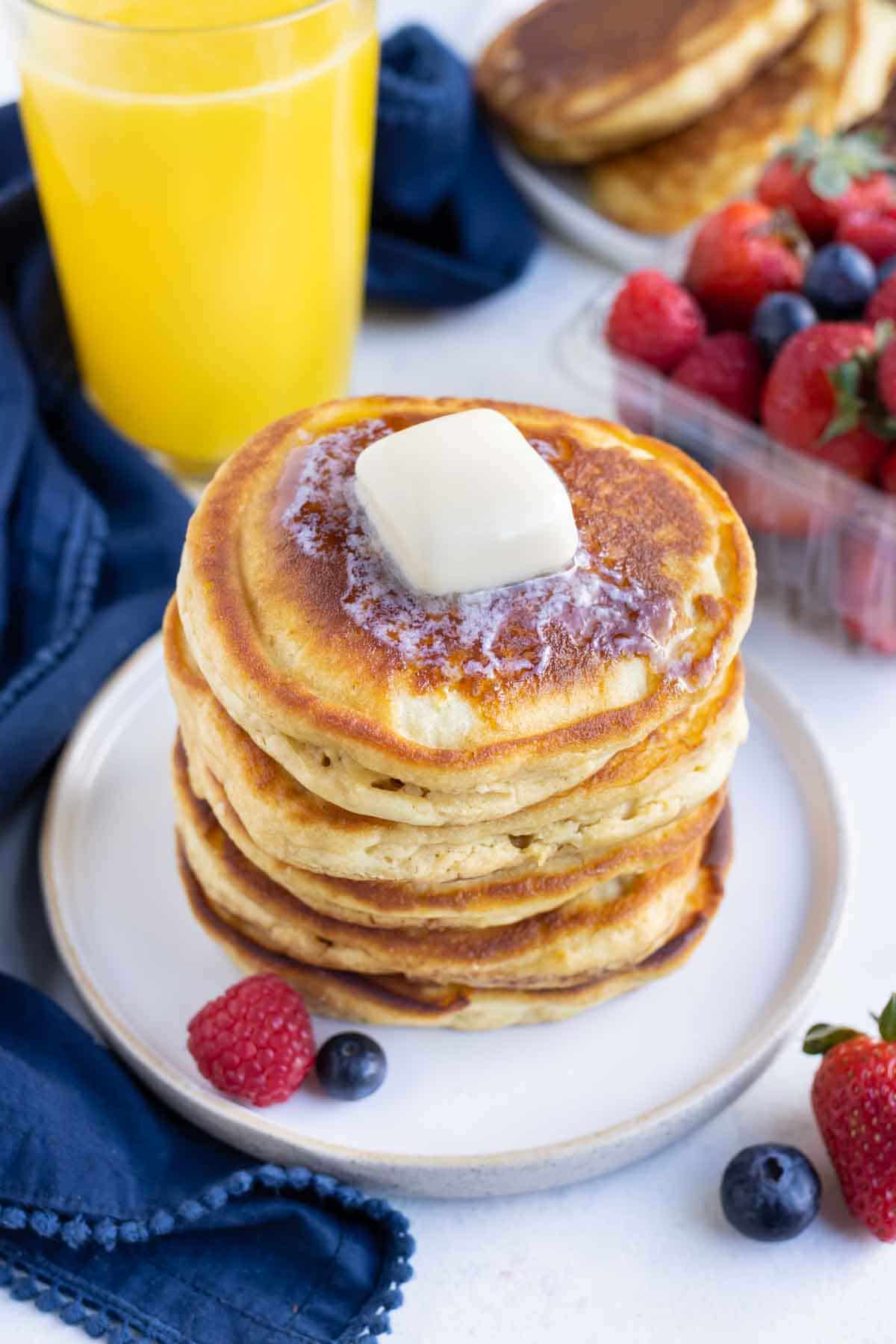 Butter Is placed on top of the pancakes.