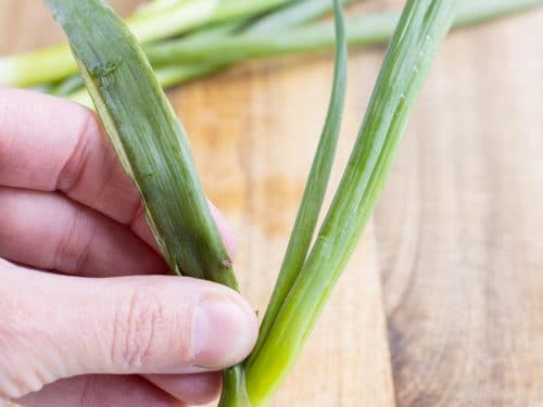 The outer leaves are taken off of the green onions.