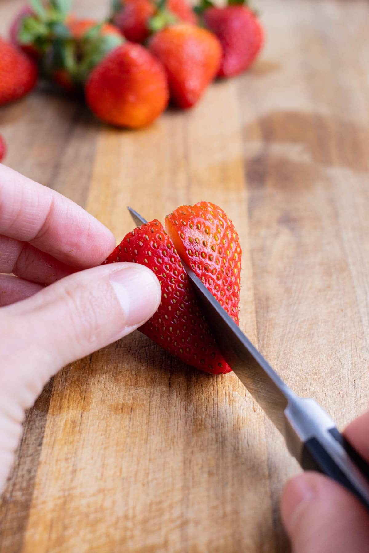 Strawberries are cut in half.