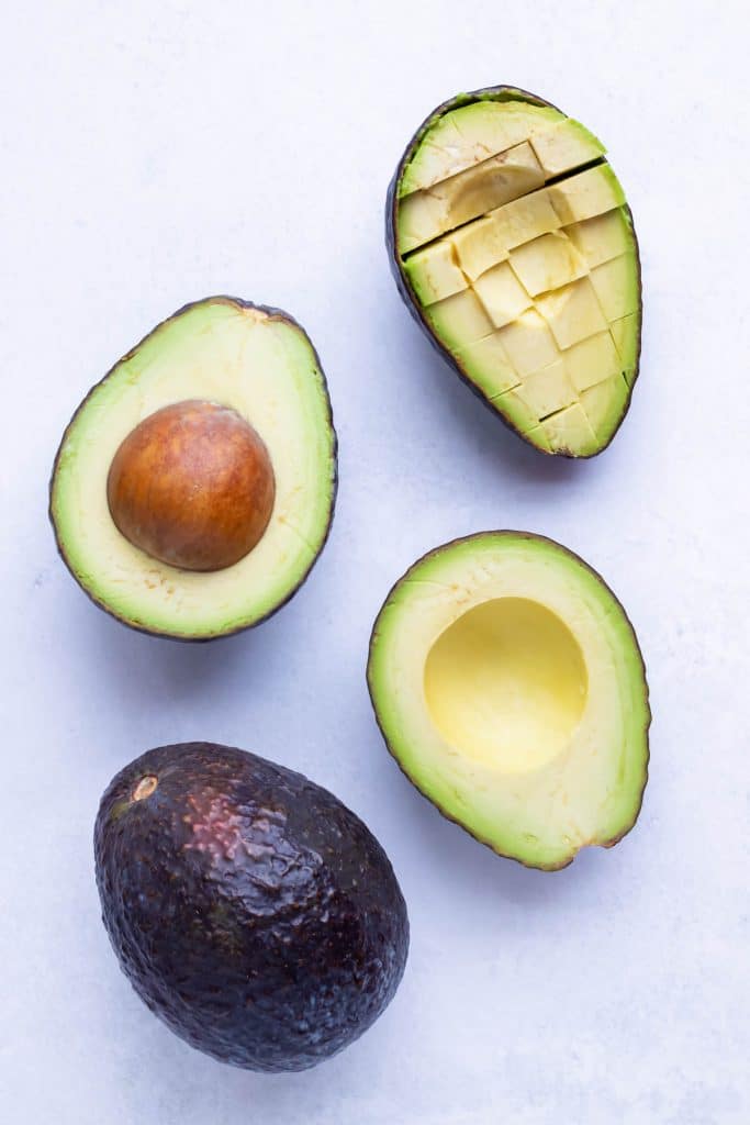 The stages of cutting up an avocado are shown side by side.