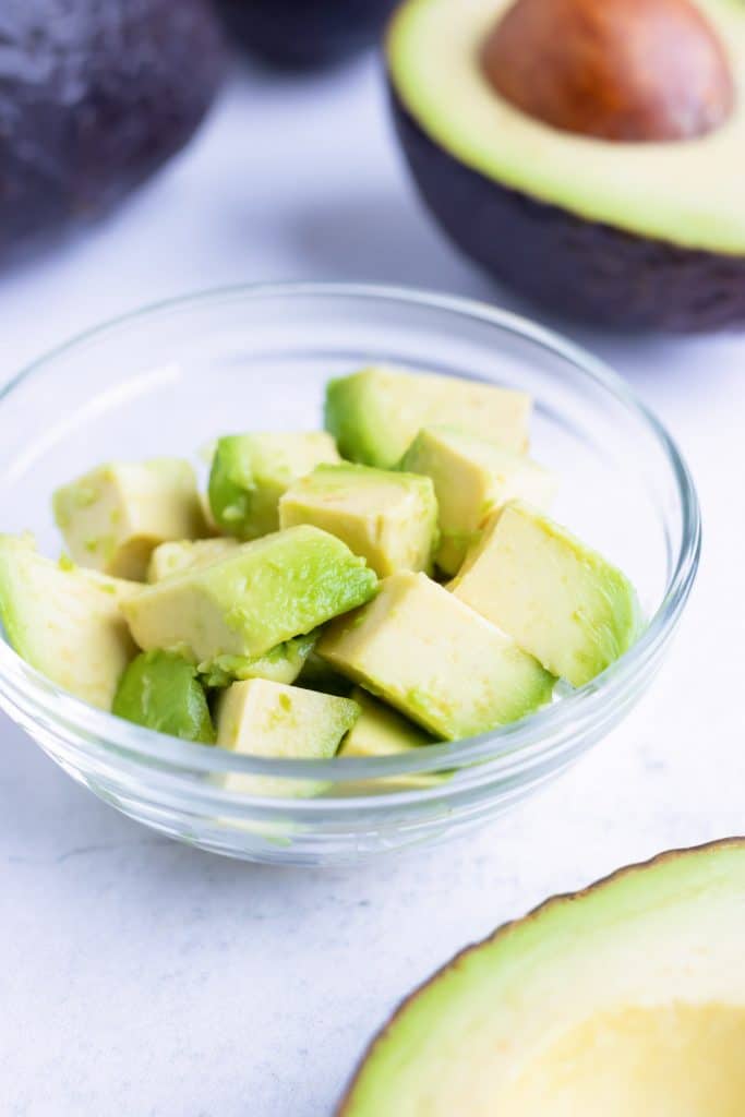 Avocado cubes in a clear class bowl.