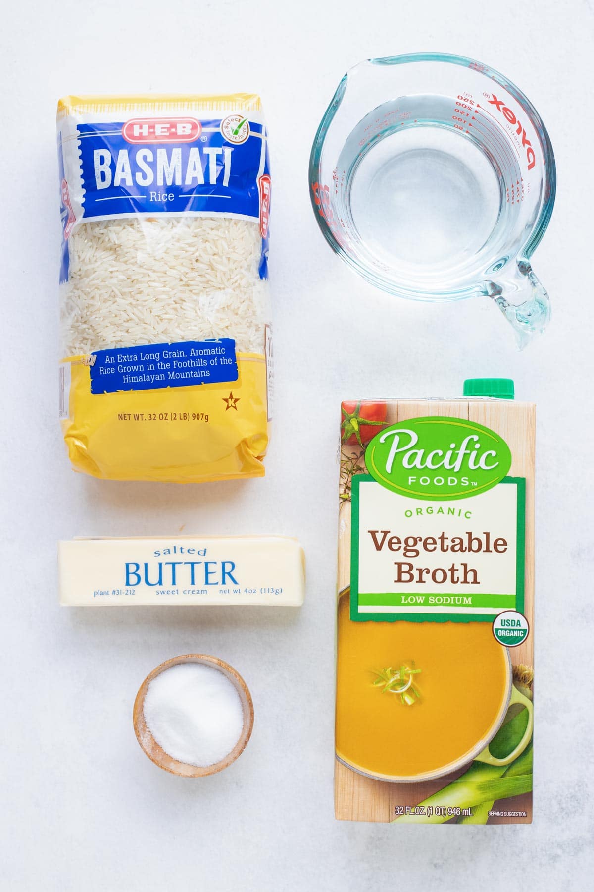 The ingredients for instant pot basmati rice are arranged on a white countertop.