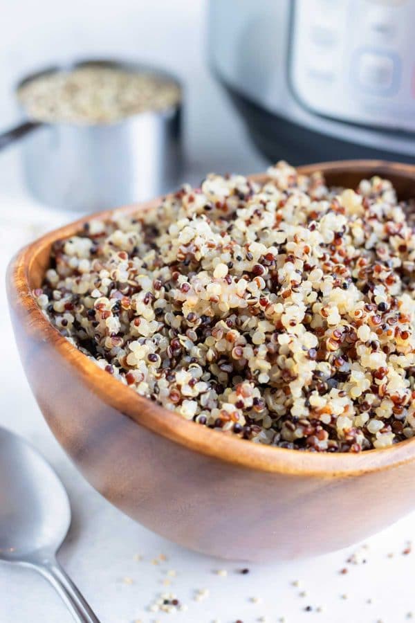 Fluffy quinoa that was cooked in an Instant Pot in a wooden bowl.