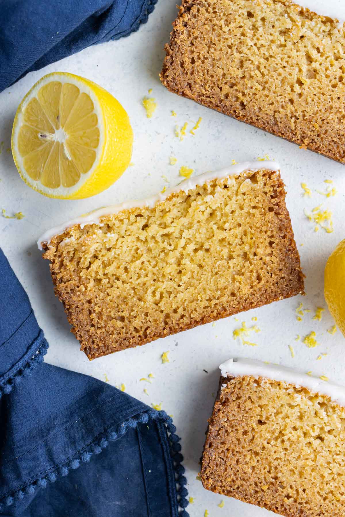 Slices of gluten-free lemon loaf are shown on the counter.