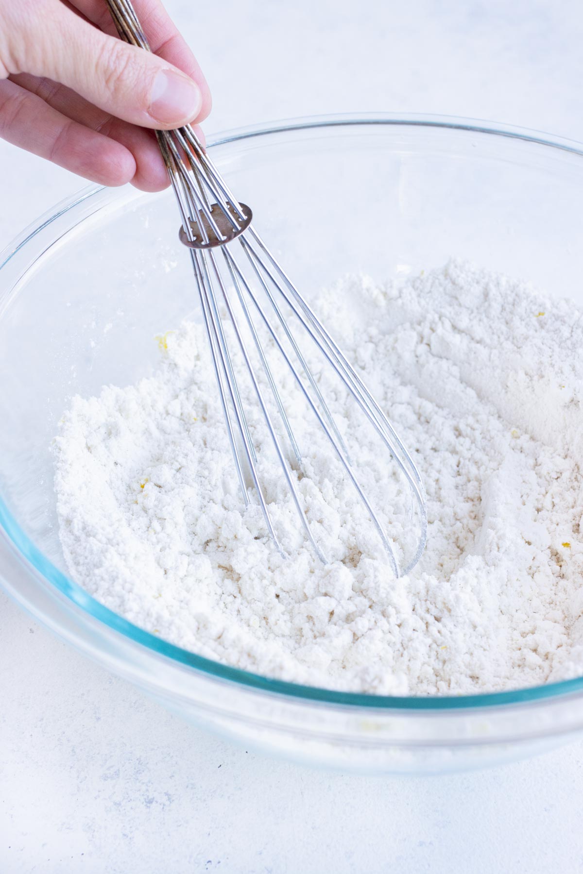 Dry ingredients are mixed together in a bowl.