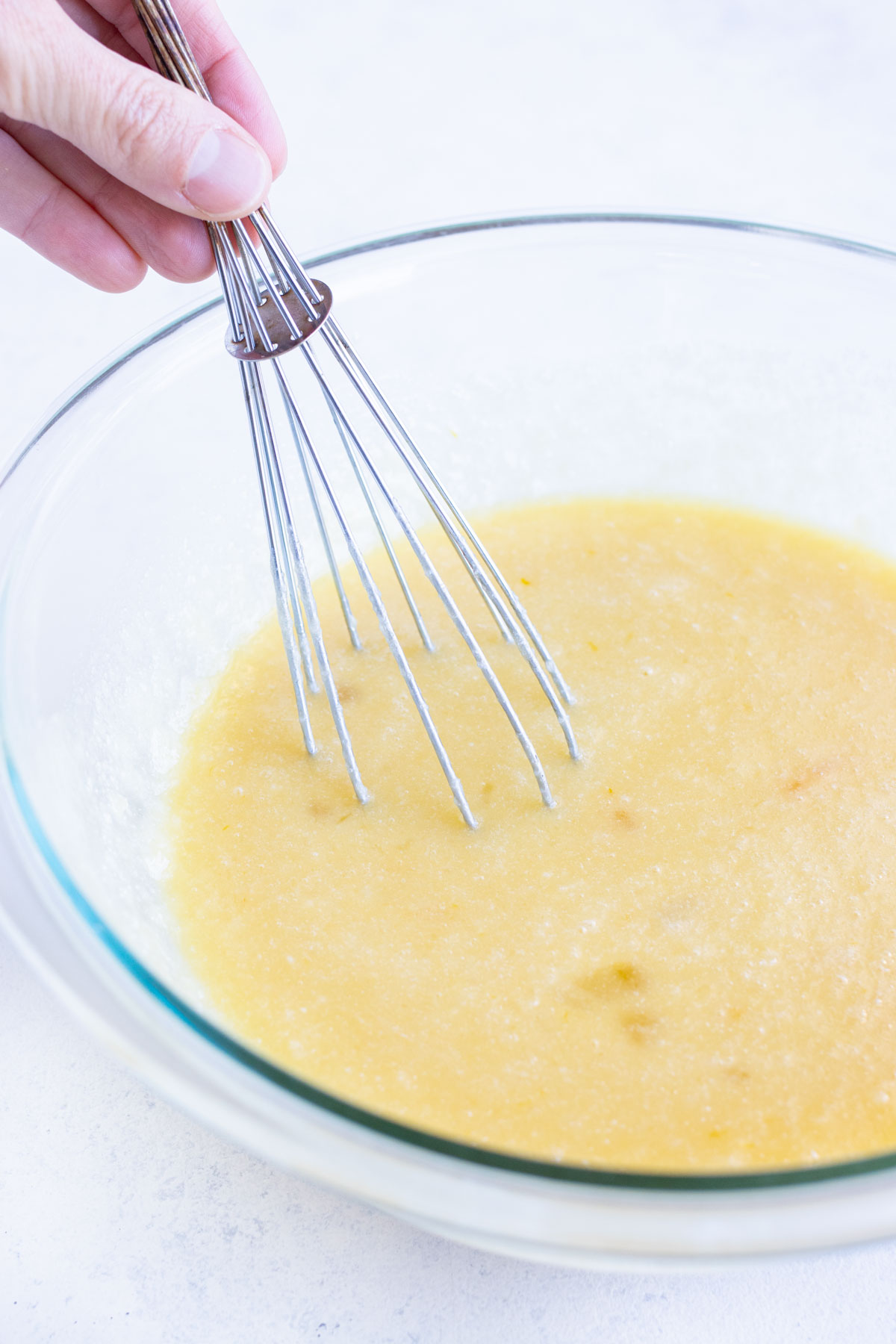 Eggs, milk, and other wet ingredients are mixed together in a separate bowl.