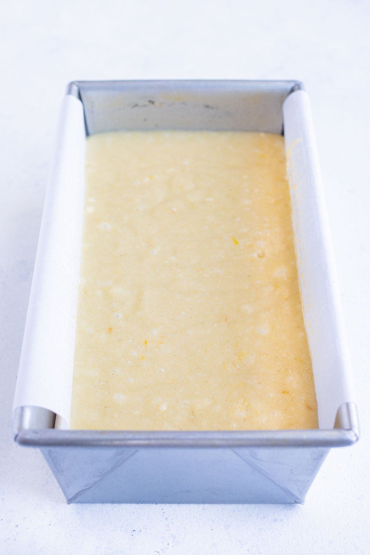 Mixture is poured into a loaf pan lined with parchment paper.