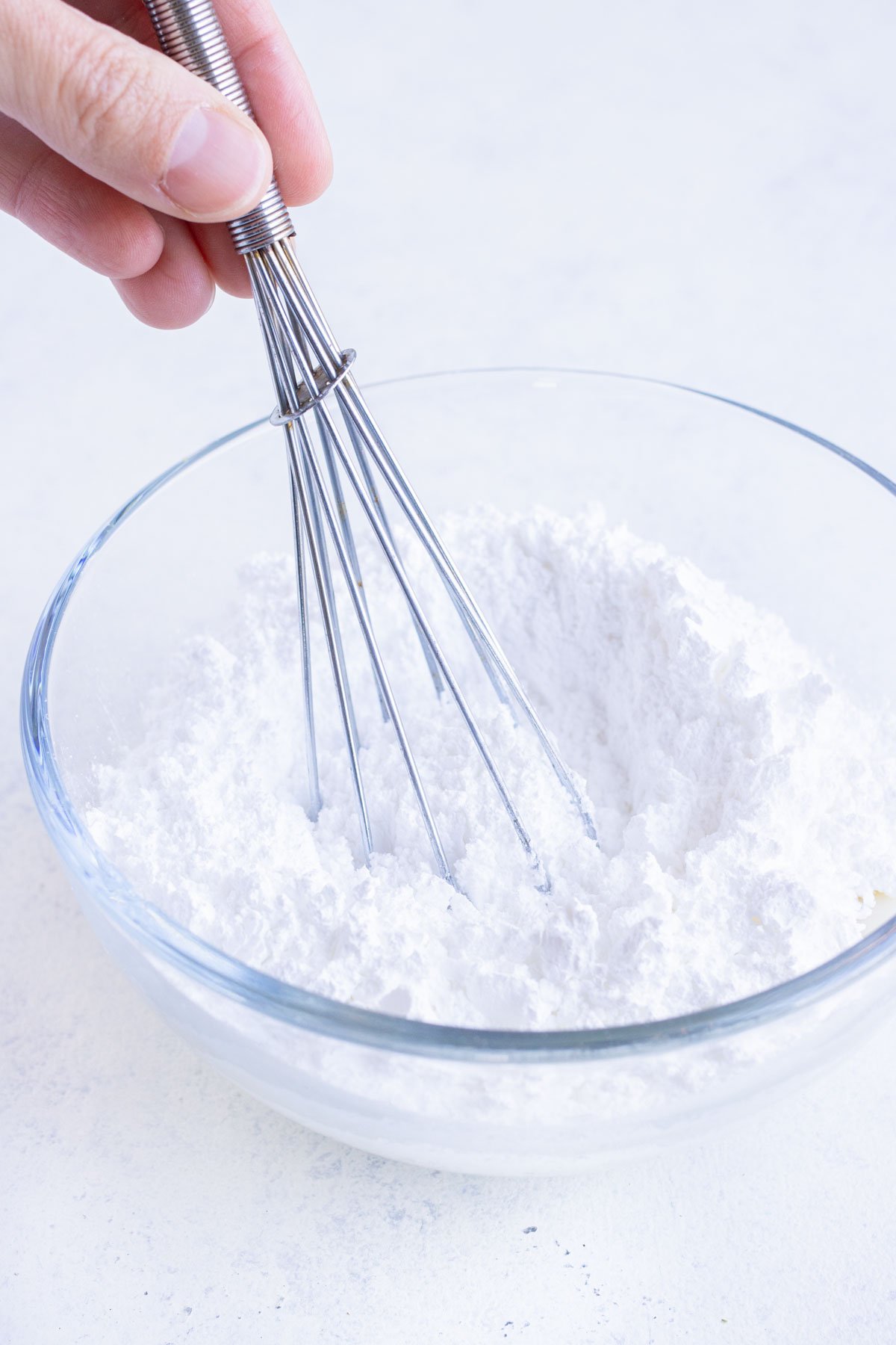 Powdered sugar is whisked together with milk and lemon juice.