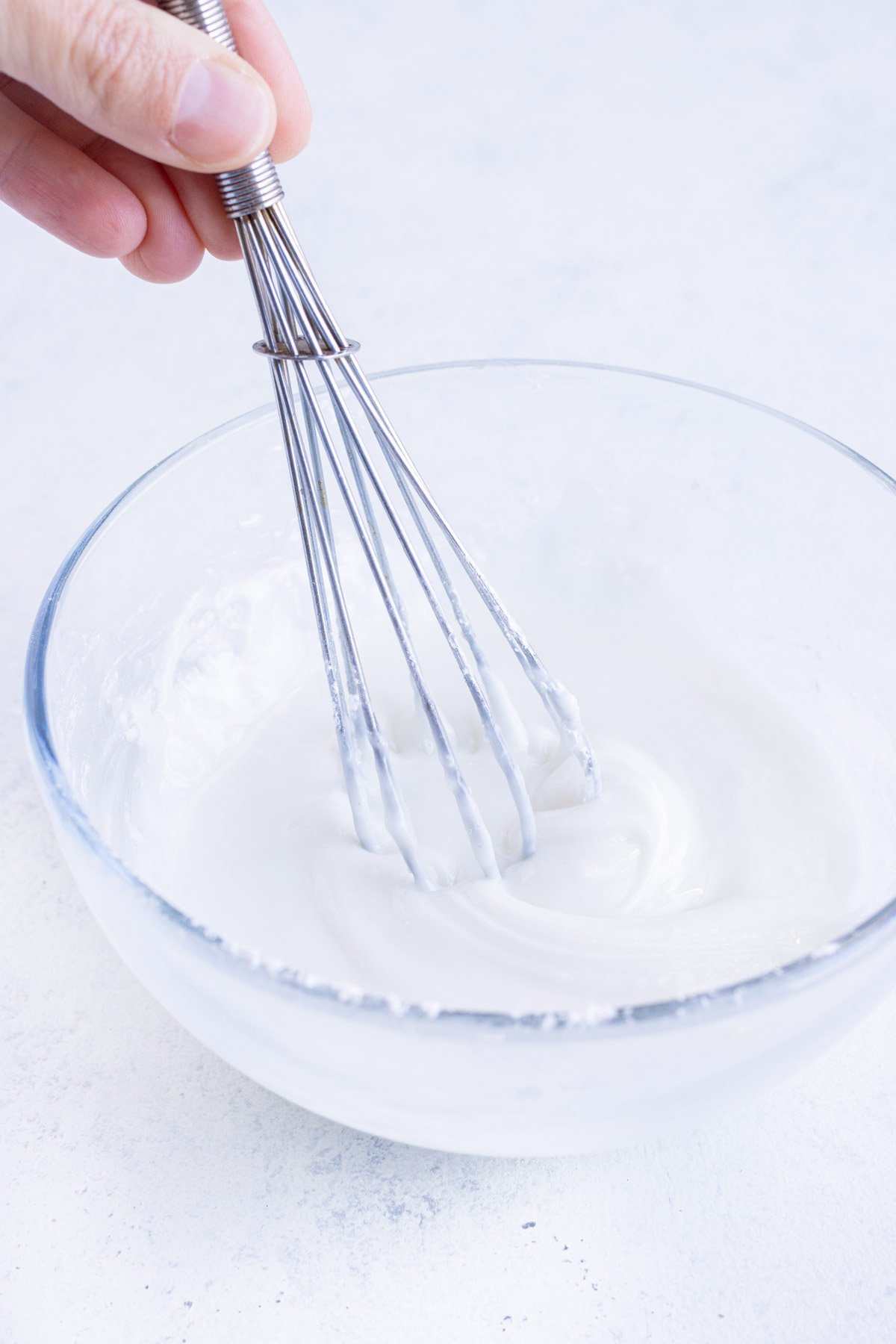 Lemon glaze is made by mixing glaze ingredients in a small bowl.