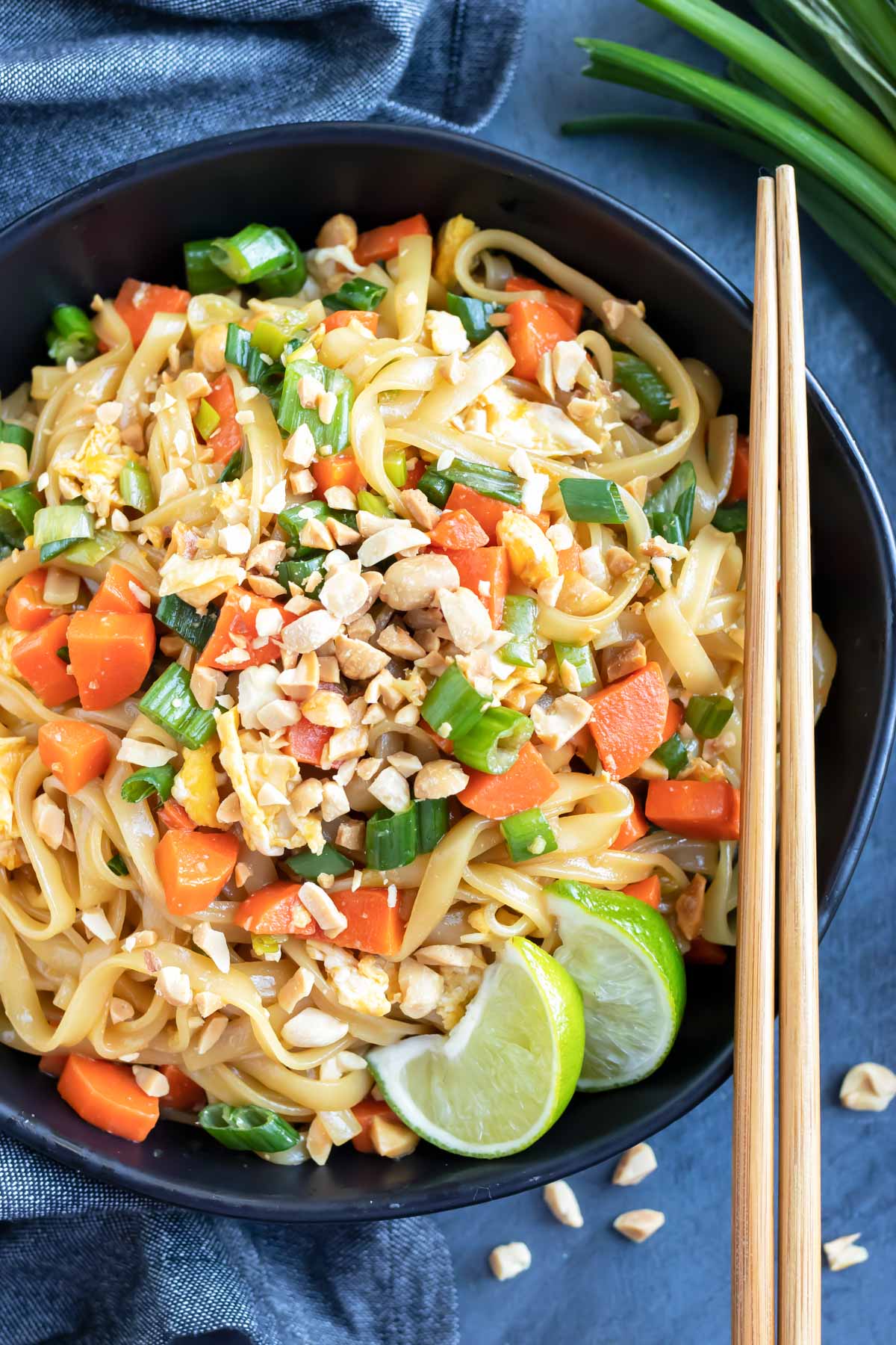 A large bowl full of a healthy and easy Pad Thai recipe with gluten-free soy sauce and peanuts.