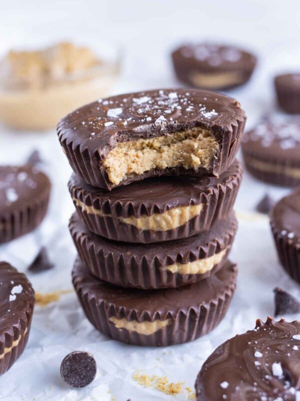 Easy homemade peanut butter cups are stacked on the counter for a dessert.