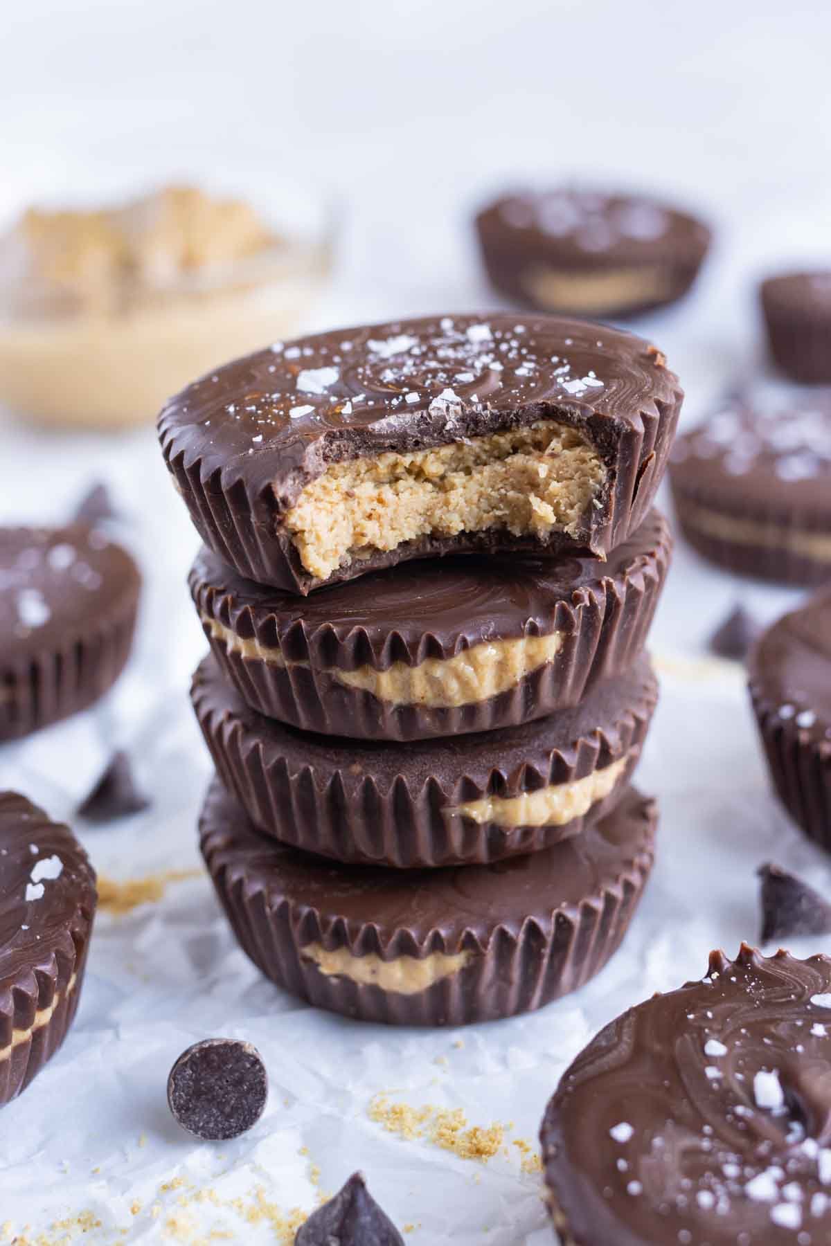 Easy homemade peanut butter cups are stacked on the counter for a dessert.