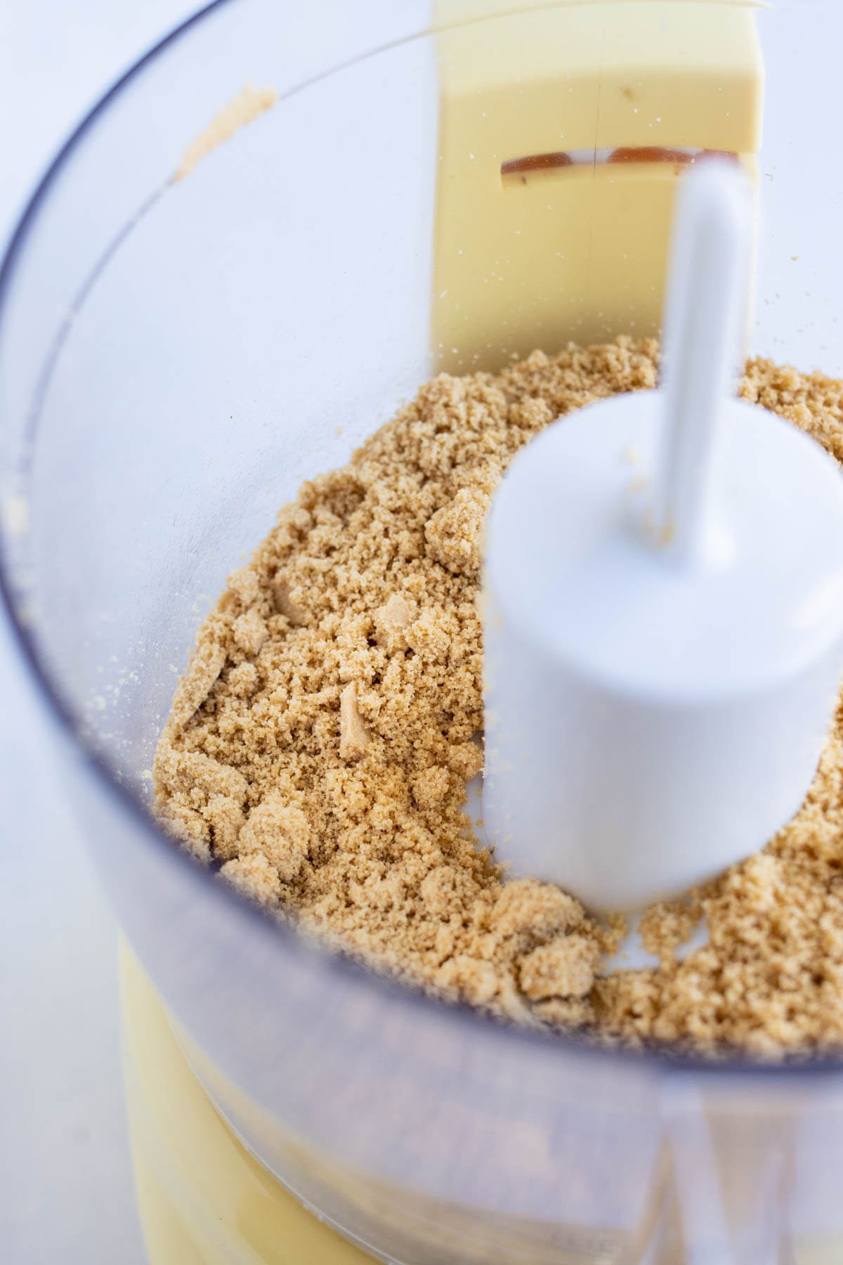 Graham crackers are crushed in a food processor.