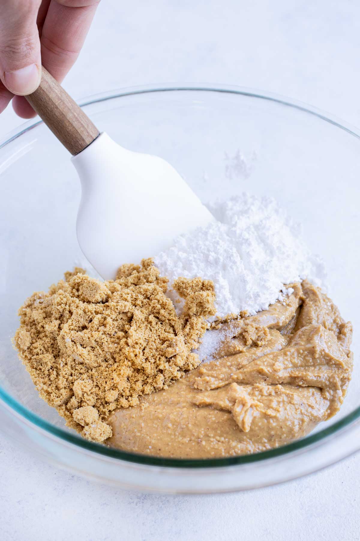Powdered sugar, peanut butter, graham crackers, salt, and vanilla are all mixed together.