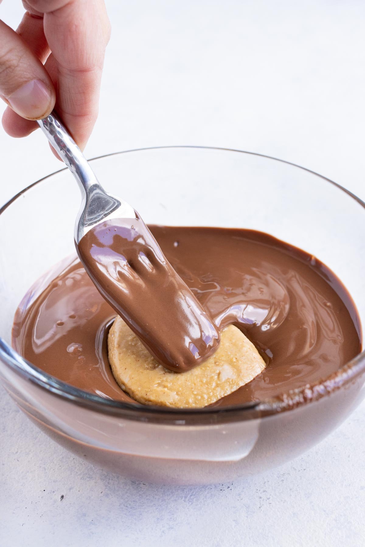 Melted chocolate is used to dip the eggs.