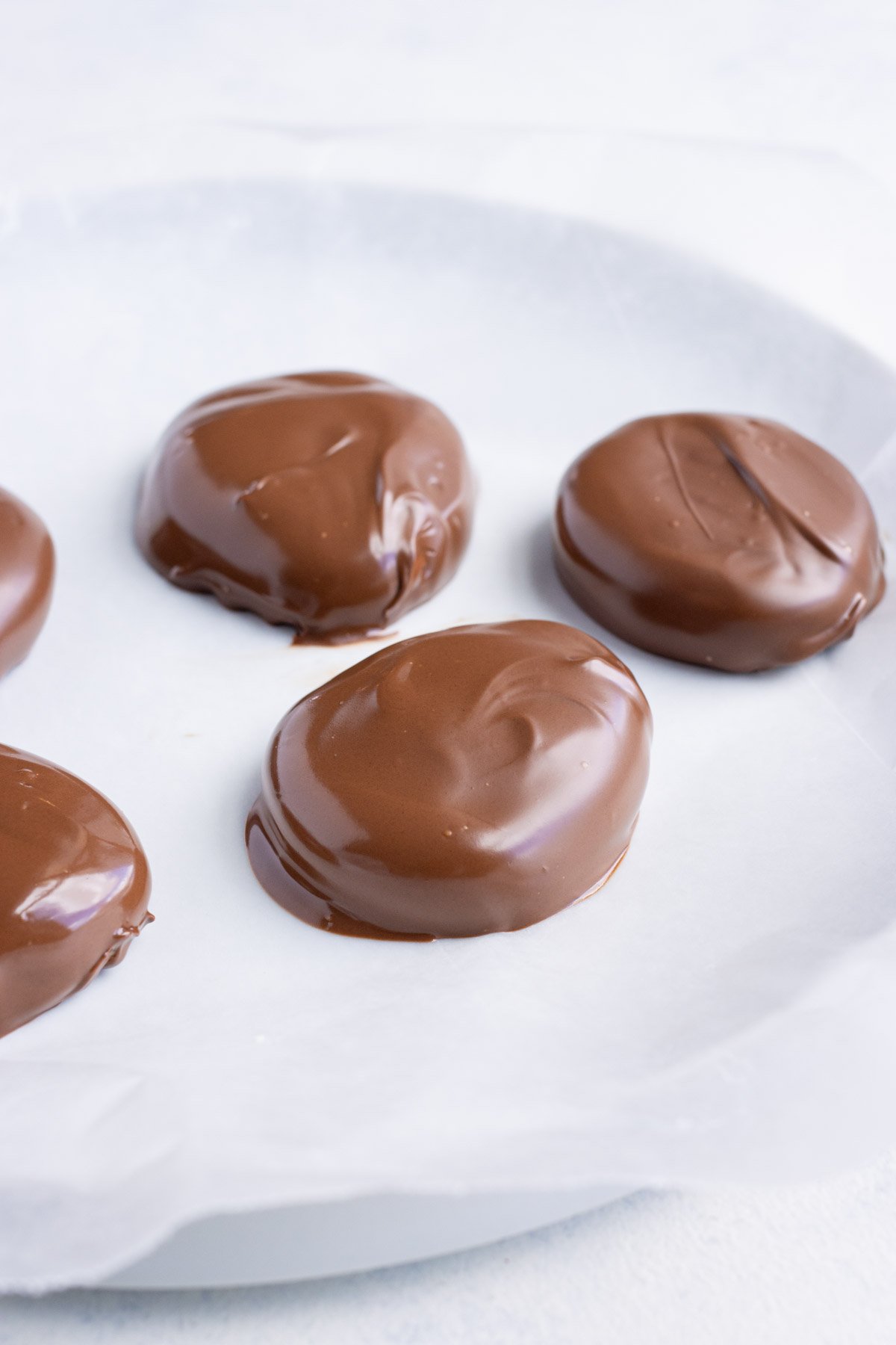 Wax paper being used to help solidify chocolate desserts.