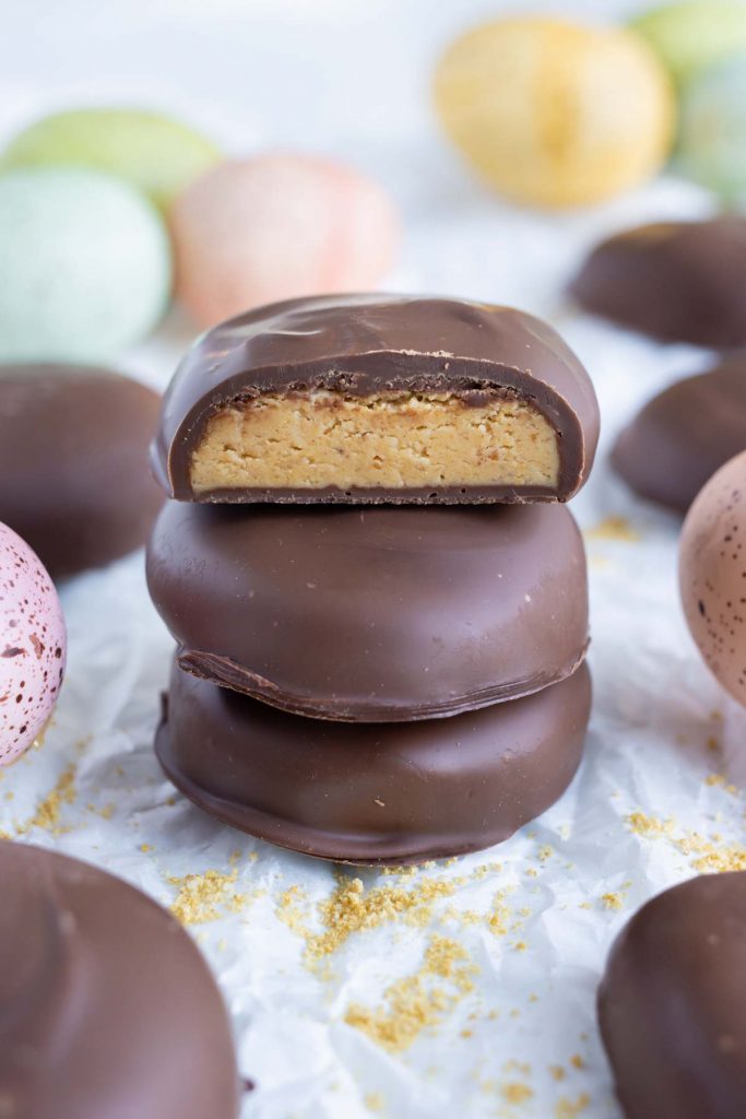 Homemade chocolate eggs are stacked on top of each other.
