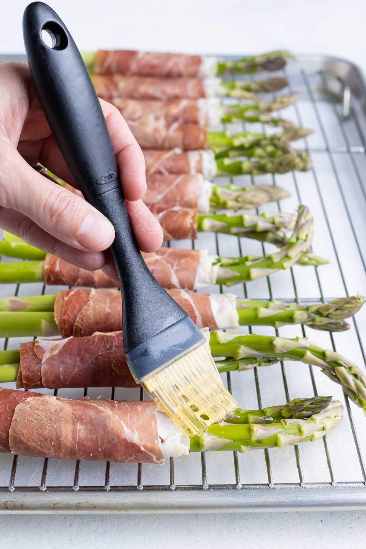 Asparagus stalks are brushed with oil and salt and pepper.
