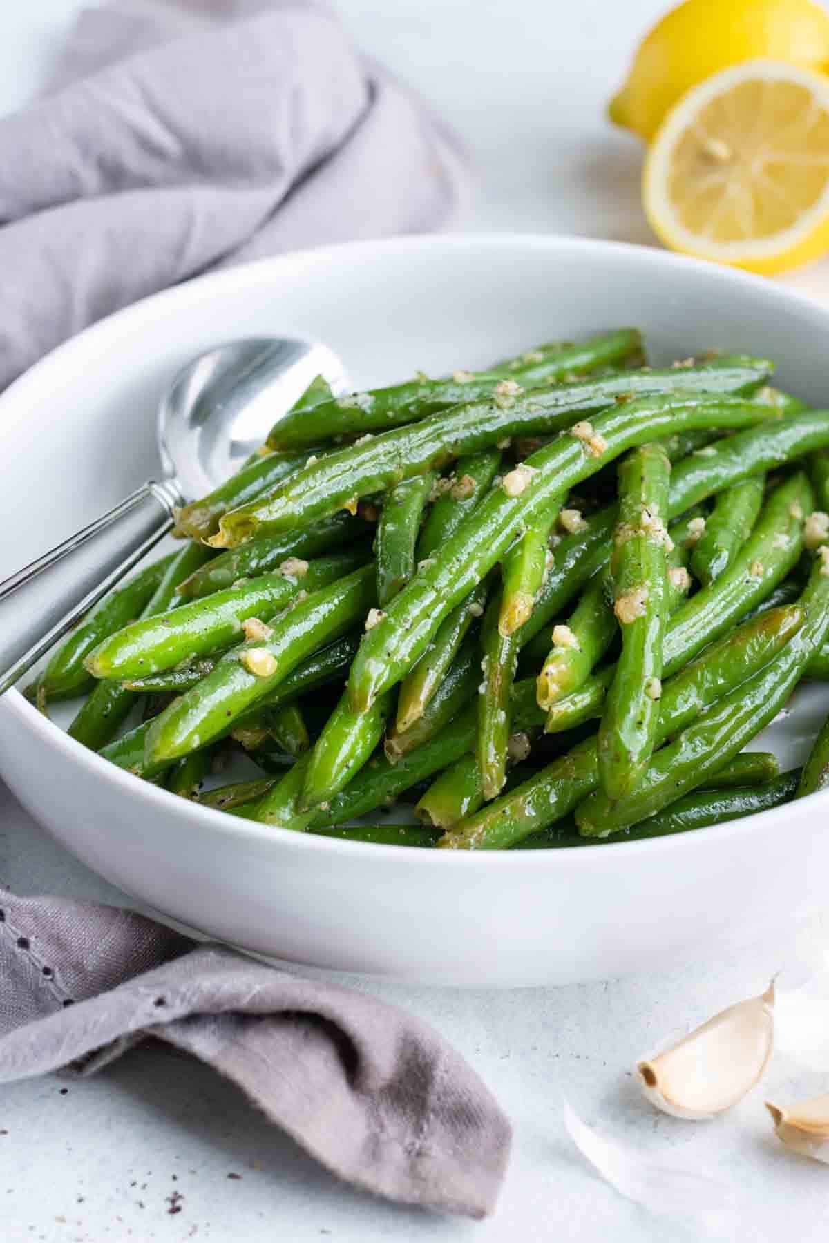 Green beans are topped with chopped nuts.