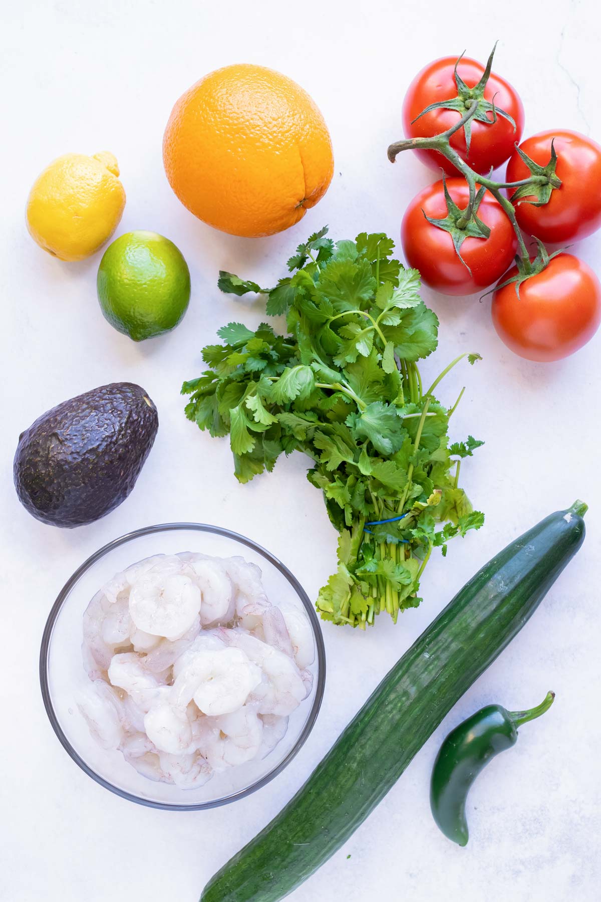 The ingredients for a Mexican shrimp ceviche with avocado and tomatoes.